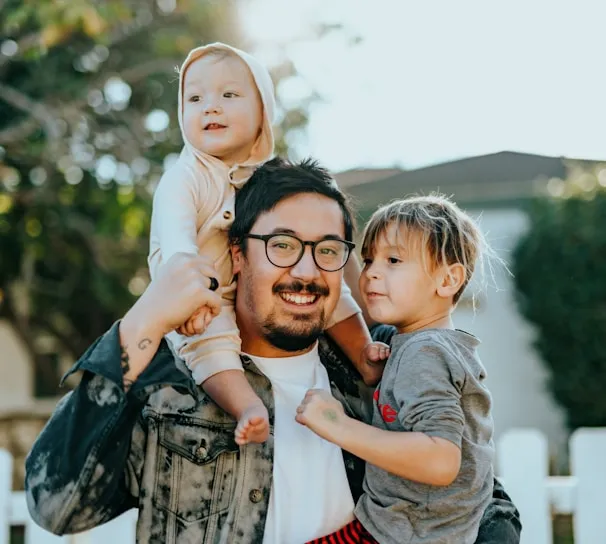 A father carrying his two children